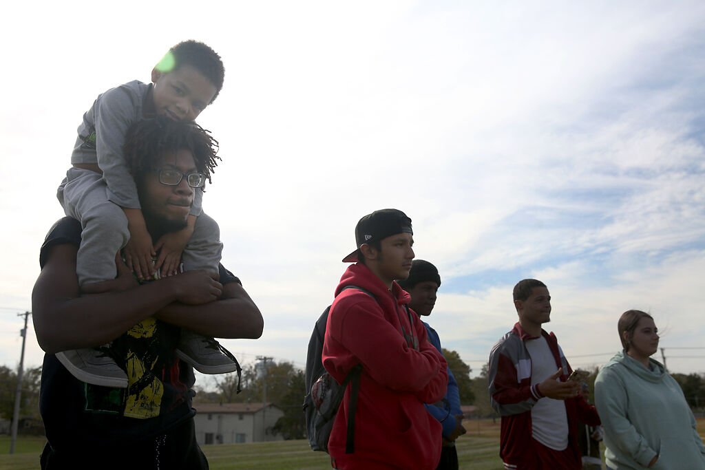 Caiden Robinson, 5, sits atop his uncle Scooby Like's shoulders